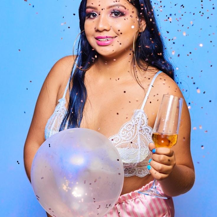 Kaveri Mehta, Lead Design Curator at CompassOpalQuarry, reviewing corporate floral arrangements